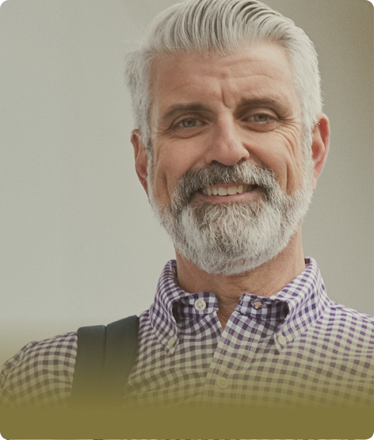 Man with white hair and beared smiling