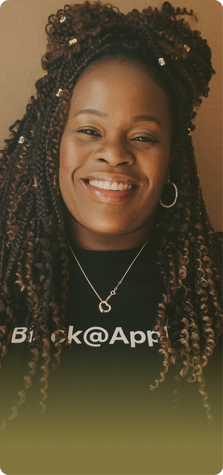 Woman with black curly hair smiling